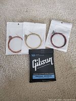 Lot of guitar strings including Gibson branded Vintage Reissue set and three other individual strings in sealed bags