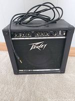 Front view of Peavey Blazer 158 amplifier with patch cable coiled on top, showing control panel and Peavey logo.