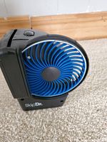 Front angle view of the SkipDr CD cleaning device showing the blue circular cleaning component and the black casing with SkipDr logo.