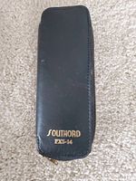 Closed black zippered leather case with gold 'SOUTHORD PXS-14' logo