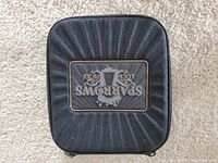 Closed black zippered carrying case with Sparrows logo on top, textured finish.