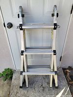 Front view of folded Vulcan ladder showing multiple steps and sturdy aluminum construction.