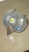 Full view of a frosted Murano glass globe lamp shade with colorful embedded murrine flower designs and metal attachment hardware on top.