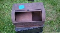 Top view showing the roll-top open door revealing inside storage compartment of the metal bread box.