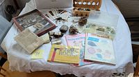 Overview of collection on a table showing loose stones, labeled minerals, and several rock/mineral books.
