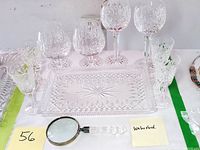 Full lot setup with stemware arranged behind the rectangular tray and magnifying glass placed in front.