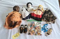 Full lot with all dolls, miniature tea set pieces, and accessories on white background.
