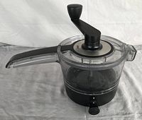 GEFU Spiralfix Spiralizer showing clear container, crank handle, and black base with adjustment knob