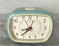 Front angle view showing clock face, hands, and color of casing.