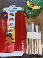 Photo showing Viovia branded gripping cutting mats and packaged designer chopsticks.