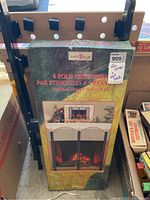 Box of Hart & Holm brand polished brass 4 fold fire screen showing product picture and branding.