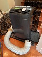 Frontal view of the unit with attached exhaust hose