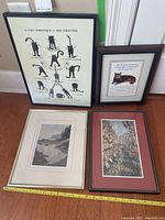 Four framed pictures arranged against a wall, showing overall lot contents including cat and landscape themed art