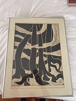 Full view of framed black and white abstract print with flowing line patterns.