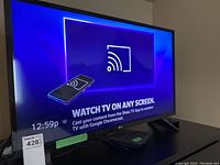 Full front view of the LG 32-inch TV powered on, displaying a screen to cast content with Google Chromecast.