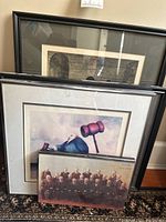 Framed artworks including two pictures with one showing gavels and one abstract black and white print; group photo of men on floor