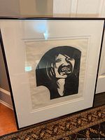 Front view of framed print showing black and white stylized portrait of a woman.