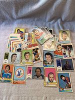 Spread of 1970s WHA hockey cards including players and team logo cards.