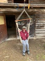 Hammock chair shown hanging with a person seated, demonstrating size and style.