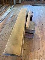 Photo showing a thick hardwood lumber board approximately 12 inches wide and 4 inches thick, with natural live edges and rough surface.