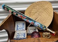 Photo of the full lot including four ceramic trays, painted umbrella, straw fan, purple glass bowl, and gold figurine