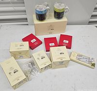 View of all boxed Lenox items arranged on a table, including two coffee mugs and several smaller boxed items