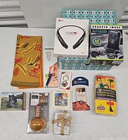 Top down image of contents of storage box including electronic devices, kitchen tool, home decor, and accessories