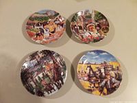 Four decorative Canadian portrait plates arranged in two rows showing colorful painted scenes depicting different provinces and cultural life in Canada.