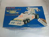 Box showing the full packaging and product image with multicolor text and branding, indicating radio control and model details.