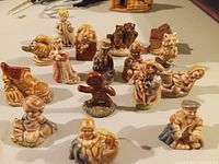 Photo showing all 16 Wade nursery rhyme ceramic figurines arranged in rows from front to back.