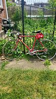 Red Schwinn Sprint road bike, full side view outdoors showing overall condition and flat tires