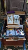 Overview of Milben drawing tools, clipboards, loose leaf paper, and other office and art supplies stacked together.