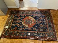 Top-down view of entire rectangular rug on hardwood floor