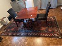 Overhead view of full rectangular rug under wooden table and chairs