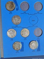 First album page showing George VI half dollars dated 1946, two 1947 varieties, 1948, 1949, 1951 and 1952