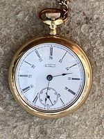 Front view: enamel dial with Roman and 24-hour numerals, subsidiary seconds, blued steel hands