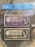 Fronts of both $10 and $20 1954 banknotes in graded CC|CS sleeves