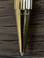 Close-up of pen tip housing showing engraved Cartier logo
