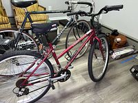 Full side view of Schwinn Soxinder ladies mountain bike showing frame, tires, saddle, and handlebars indoors on wood floor.
