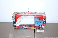 Front view of the Peterbilt garbage truck die cast model in original box on a plain surface.