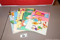 Six Walt Disney vintage comic books laid out with visible covers showing Donald Duck, Daisy Duck, and Huey, Dewey, and Louie characters.