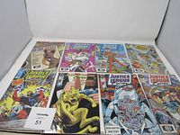 Eight Justice League Europe comic books laid out on a flat surface showing front covers with colorful illustrations and characters from the series.