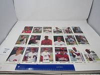Front view of 19 assorted Philadelphia Phillies baseball cards laid flat showing names and player images, with ruler for scale.