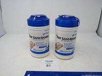 Two white cylindrical containers of PDI Sani-Hand instant hand sanitizing wipes with blue lids, side by side on white background.