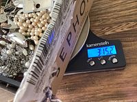 Close-up view of jewelry box on scale showing weight of over 3 pounds