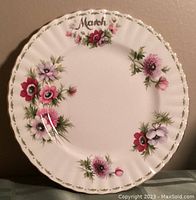 Front view of Royal Albert Flowers of the Month plate for March featuring Anemones floral design and gold-trim scalloped edges.