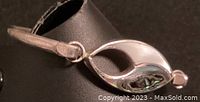 Photo showing close-up of the bracelet's clasp and mother of pearl/abalone inset detail.