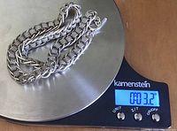 Silver heavy toggle chain necklace shown on a scale displaying 3.2 ounces.