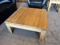 Front view of the square vintage coffee table made of solid oak showing wood grain and surface detail.