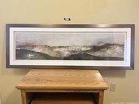 Frontal photo of full framed art showing its size and framing style.